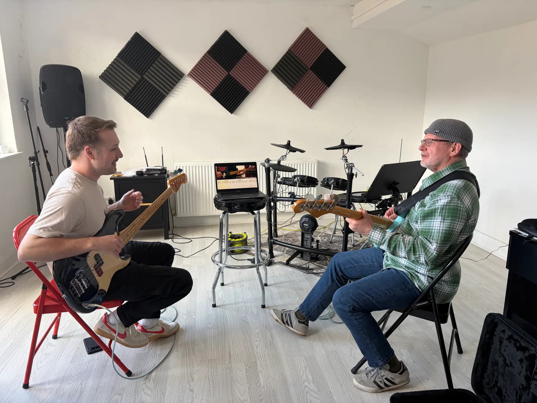 A bass teacher and student working together during a lesson