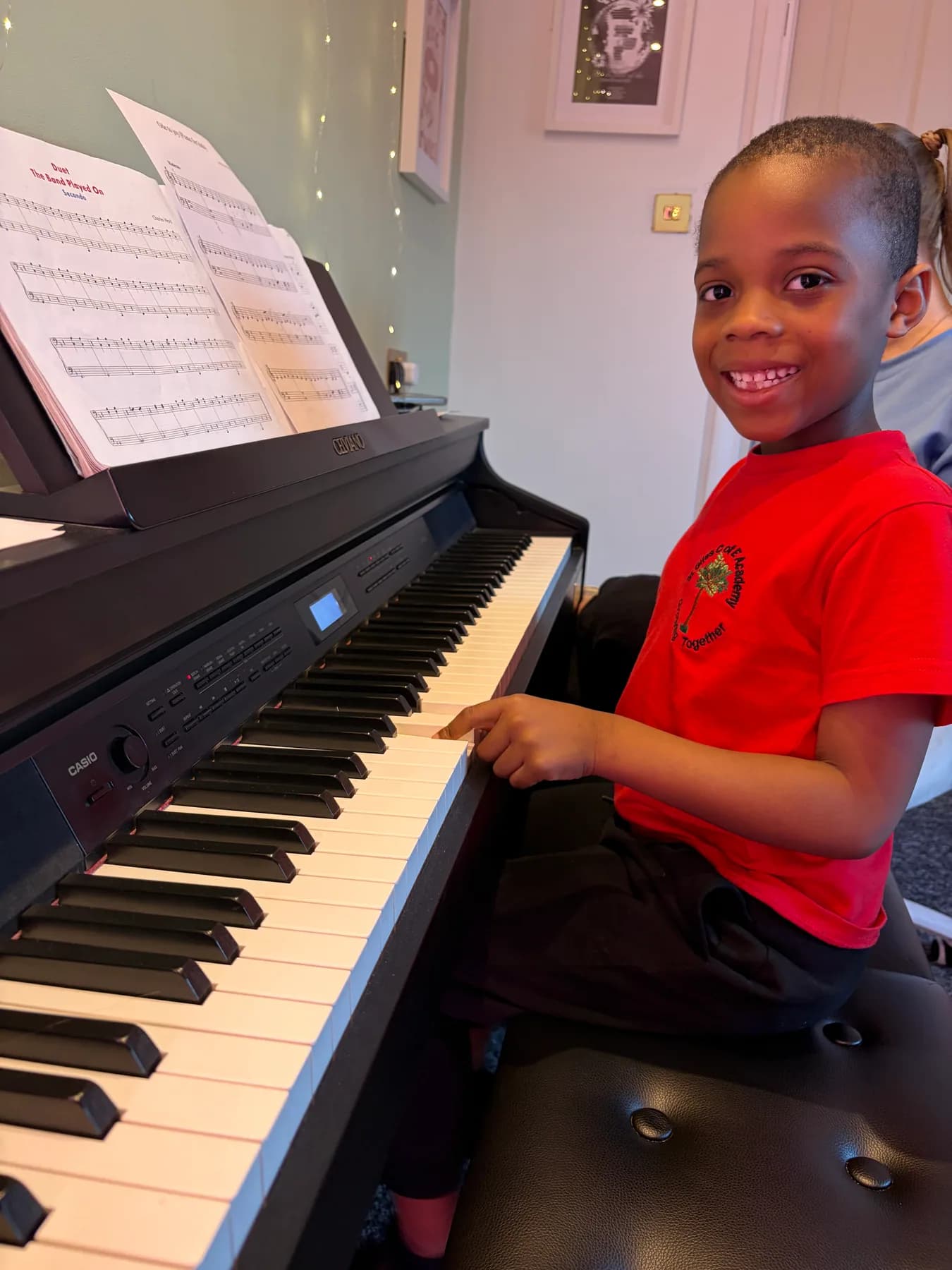 A young Apollo student enjoying a piano lesson