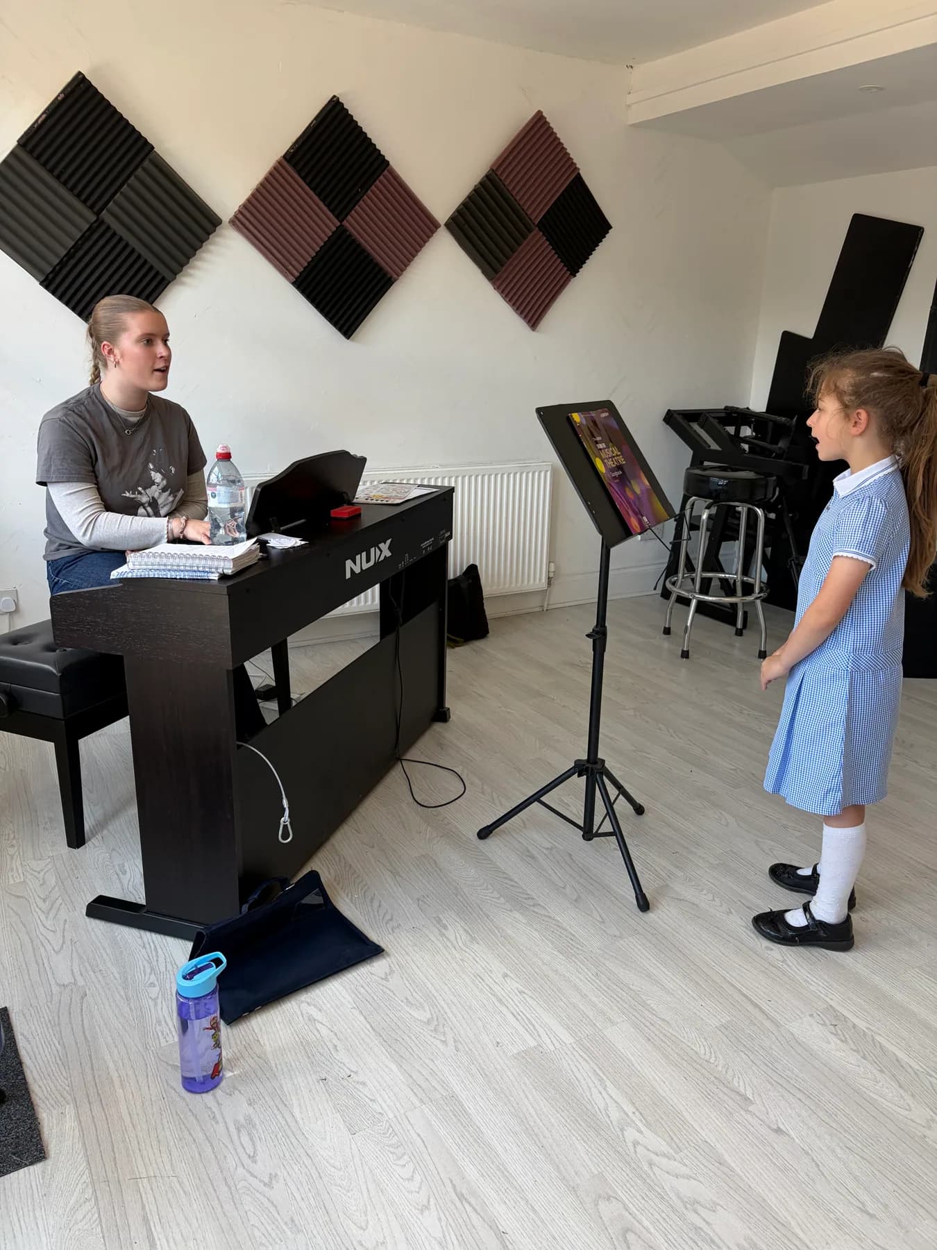 A vocal teacher working one-to-one with a young singer