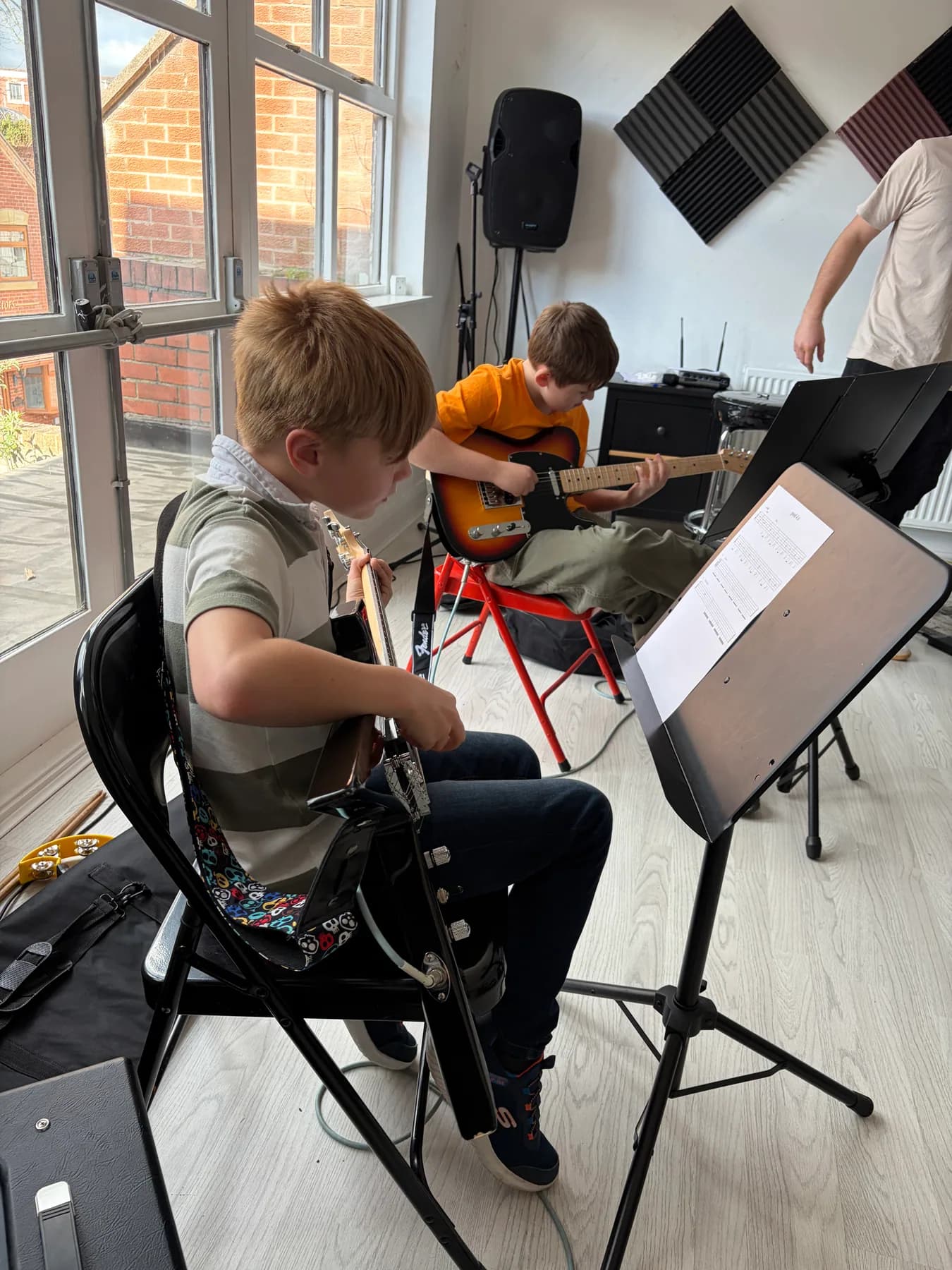 Two young guitar students playing together at Apollo