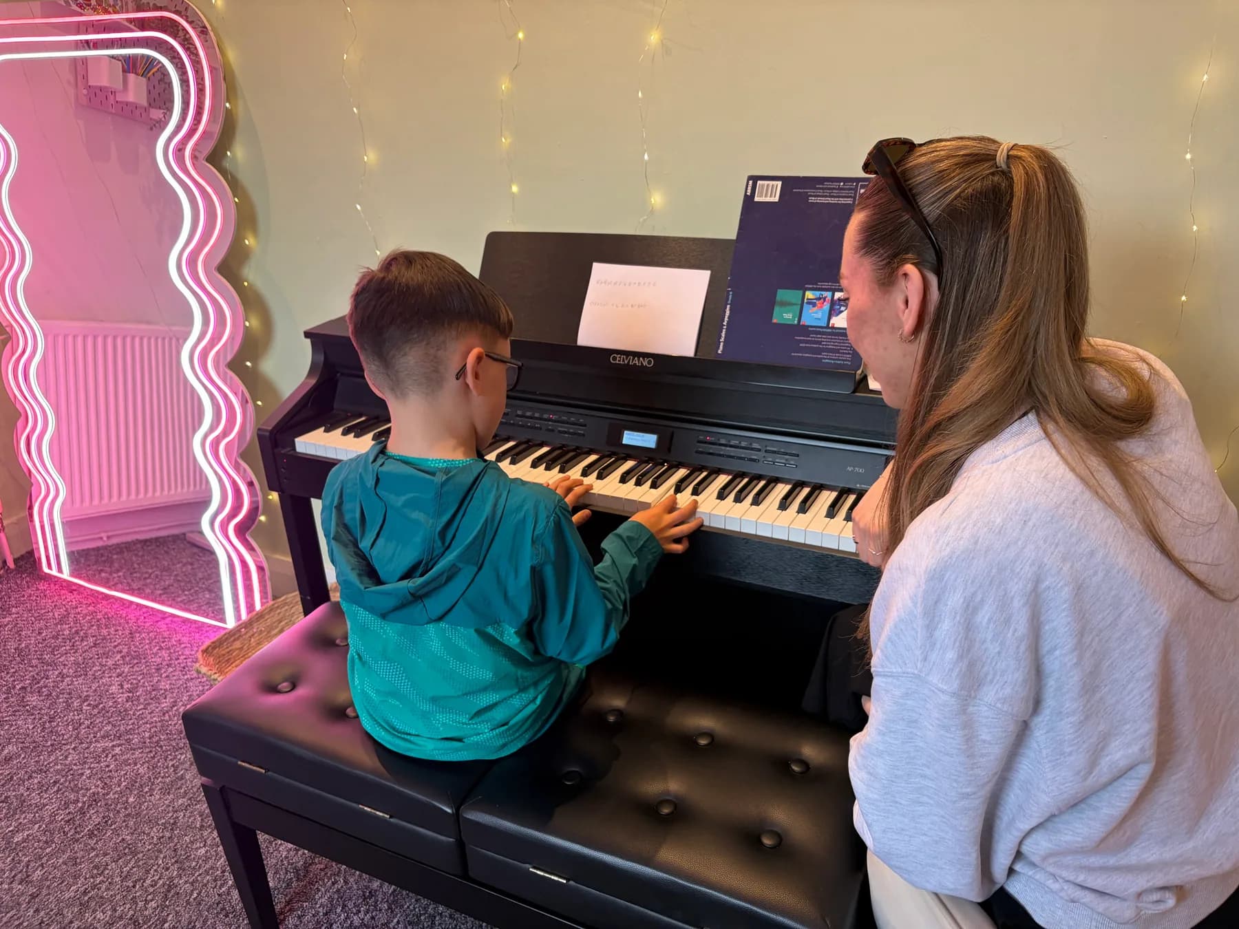 An Apollo teacher giving an individual piano lesson